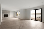 Empty living room with stone fireplace, herringbone tile floor, and lake view through sliding doors